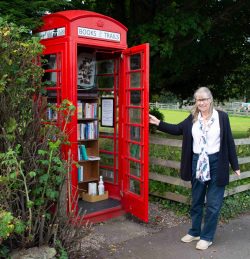 Diana Murray showing the inside of the Phonebox